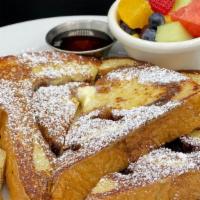 Cinnamon Swirl French Toast · Two slides of our cinnamon swirled challah bread dipped in spiced egg batter