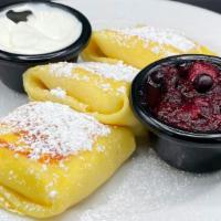 Cheese Blintzes · Three fresh crepes filled with sweet cheese filling, served with warm berry compote & sour c...