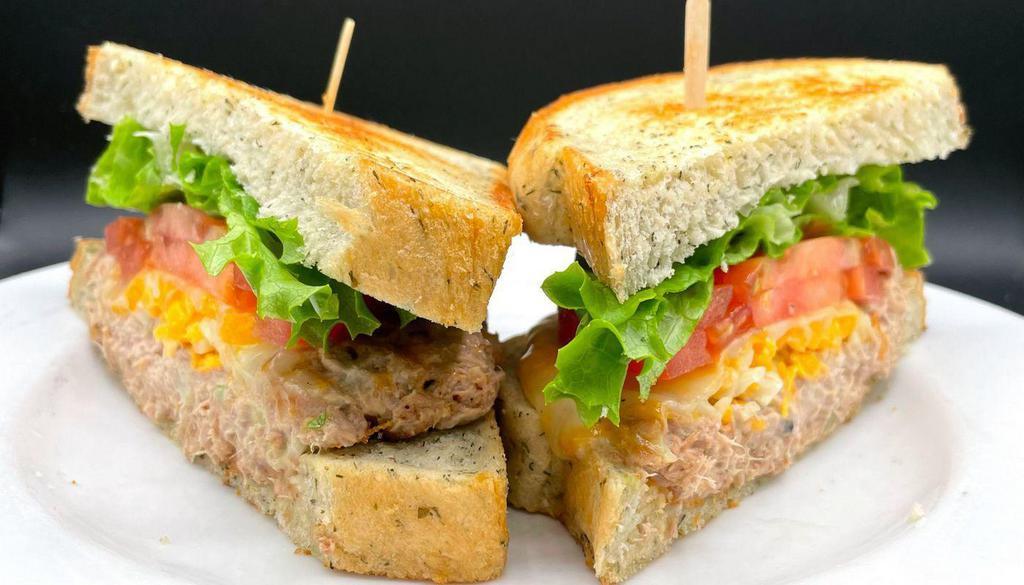 Grilled Tuna Melt (Hot) · Grilled tuna with melted cheese, lettuce & tomato, served with grilled herb bread