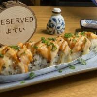 Lion King · Crabmeat, avocado topped with salmon garlic sauce, and unagi sauce, sesame, baked.