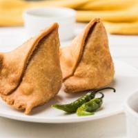Samosa Chili · Crispy, savory pastry with potatoes, peas, fresh bell peppers, and onions. Served with a dem...