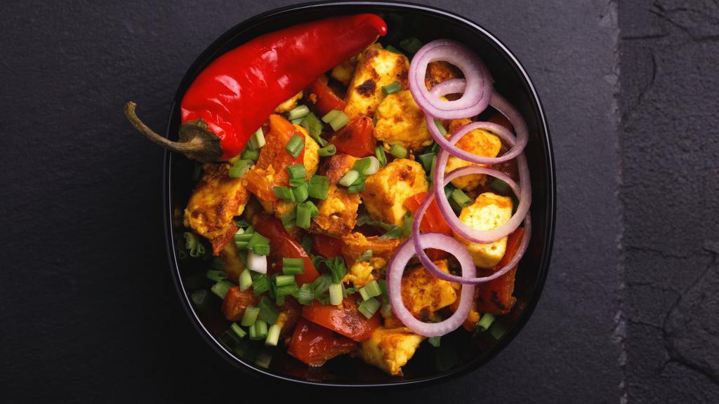 Paneer Chili · Creamy cottage cheese cooked with chopped bell peppers, onions, and tomato with a spicy demi-glace sauce.