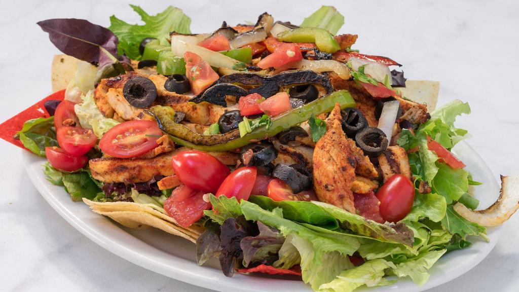 Chicken Fajita Salad · Grilled chicken with grilled onions and bell peppers on a bed of lettuce and salsa fresca.