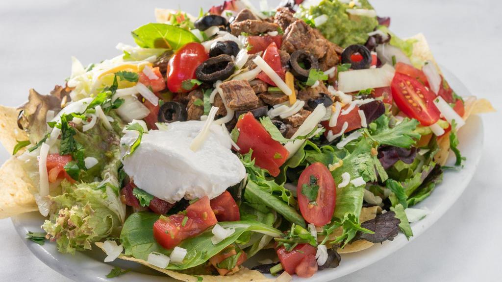 Taco Salad · Choice of meat or beans with lettuce, salsa fresca, sour cream, guacamole, cheese and olives on corn chips.