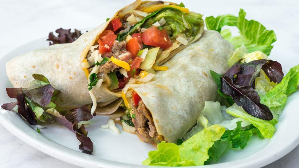 Cheesesteak Burrito · Lettuce, salsa, steak, melted cheese, guacamole and grilled bell peppers and onions.