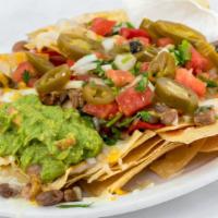 Super Nachos · Chips topped with beans, melted cheese, choice of meat, sour cream, guacamole, salsa fresca ...