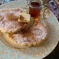 Cinnamon Pancakes · 2 large buttermilk cinnamon pancakes with butter and syrup.