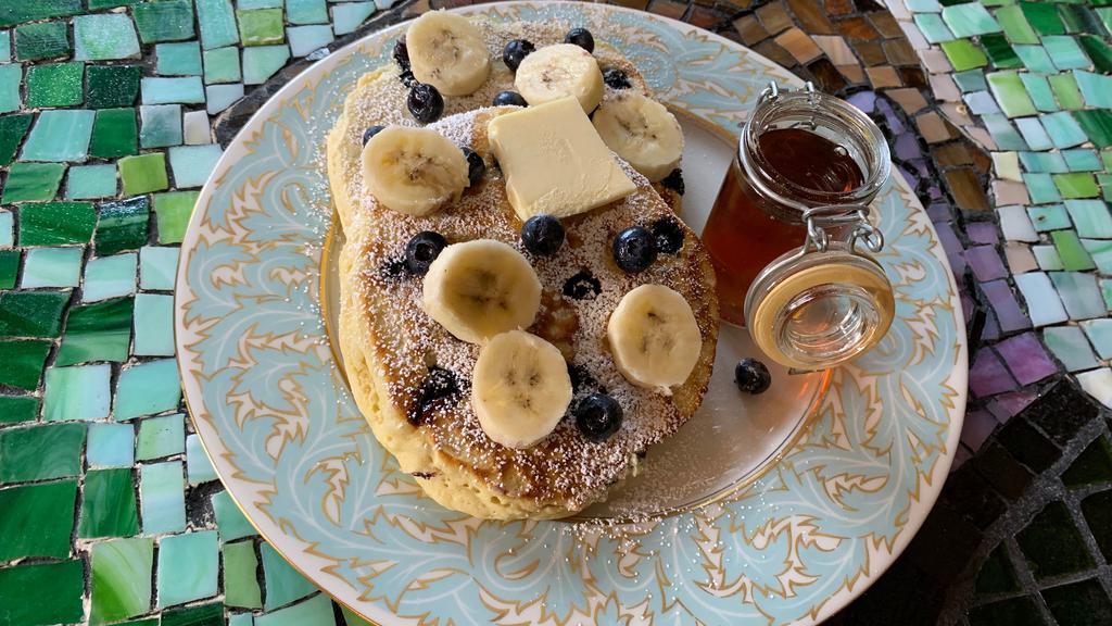 Blueberry-Banana Pancakes · 2 large buttermilk pancakes with blueberry, bananas, syrup and butter.