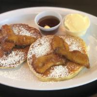Caramelized Pear Pancakes · 2 large caramelized pear buttermilk pancakes with syrup and butter.