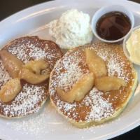 Caramelized Apple Pancakes · 2 large caramelized granny smith apple buttermilk pancakes served with syrup and butter.