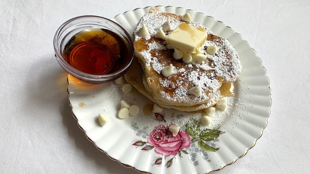 White Chocolate Pancakes · 2 large buttermilk pancakes with white chocolate morsels served with butter and syrup.