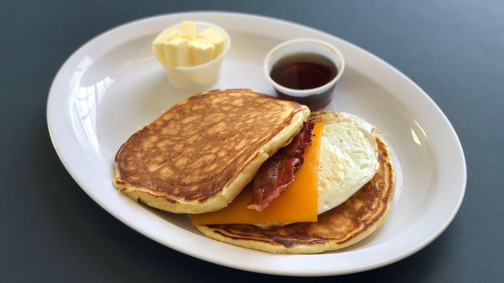 Bacon, Egg ＆ Cheddar Pancake Sandwich · Sandwich built with pork and cheese.