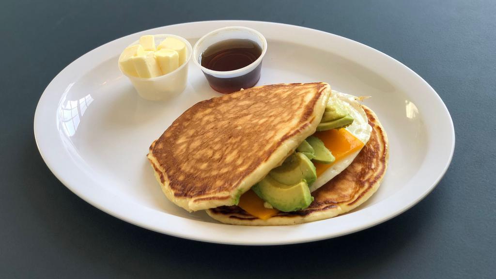 Egg, Avocado ＆ Cheese Pancake Sandwich · Sandwich built with pork and cheese.