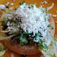 Sope · Handmade corn masa thick tortilla with choice of meat.