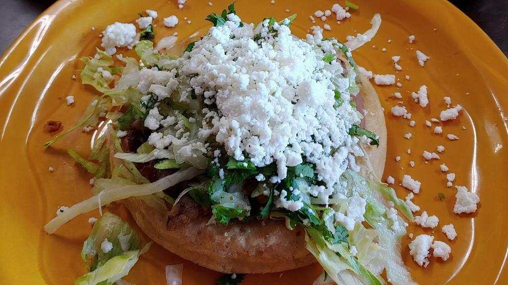 Sope · Handmade corn masa thick tortilla with choice of meat.