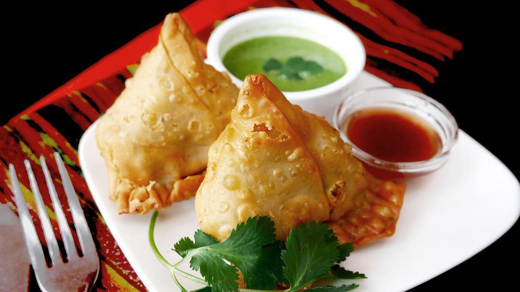 02. Veggie Samosa (2 Pieces) · Vegan. Crispy triangle turnovers with potatoes, peas, and spices filling.