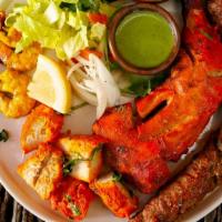 18. Tandoori Sampler · Kebab, tandoori chicken, chicken boti, and prawns.