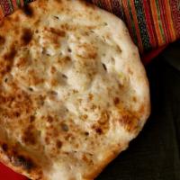 55. Naan (Plain) · Freshly clay oven-baked flat bread.