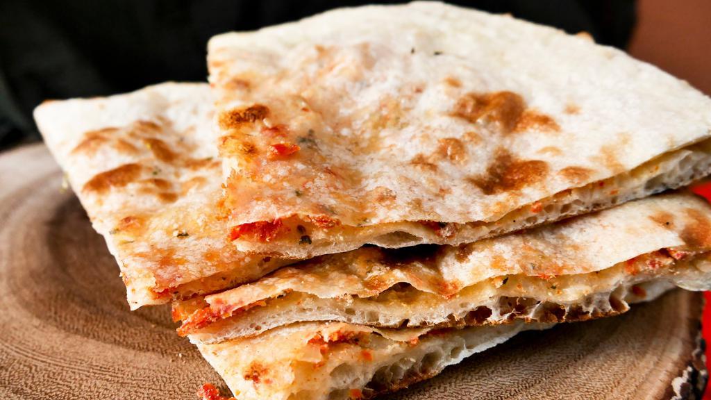 62. Goat Cheese Naan · Naan stuffed with goat cheese and fresh herbs.