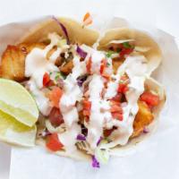 Fish Taco · corn tortilla, california or baja style fish, cabbage, pico de gallo, crema & salsa.