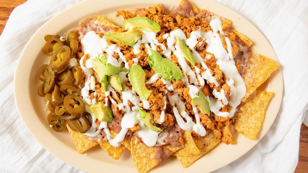 Super Nachos · Any meat, chips, refried beans, cheese, sour cream, avocado and jalapeños.