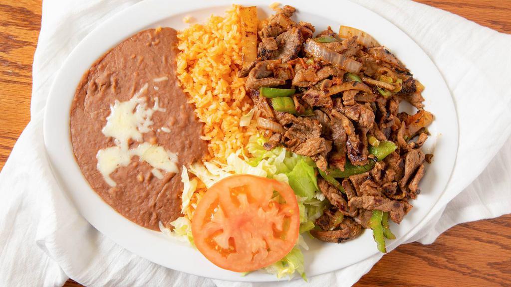 37. BEEF FAJITAS · Beef cooked with green pepper & onions served with rice beans & tortillas.