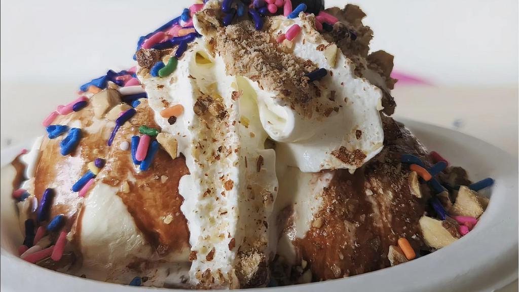Sundae · w/ 2 scoops ice cream, 1 topping, nuts, whipped cream + amarena cherry.