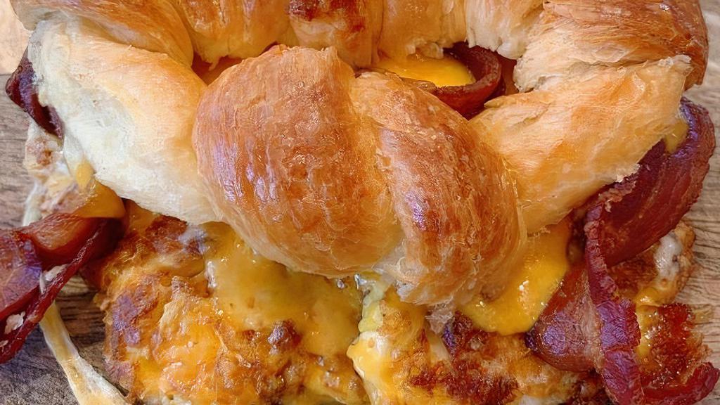 Bacon Croissant Breakfast Sandwich · Fresh Baked Butter Croissant topped with Crispy Boar's Head Bacon, Eggs, and topped with Cheese.