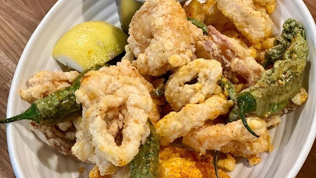 Fried Calamari and Rock Shrimp · calamari and rock shrimp dredged in piment d'ville seasoned flour and fried in rice bran oil with basil, lemon and shishito peppers, and lemon aioli. gluten free. Gluten Free