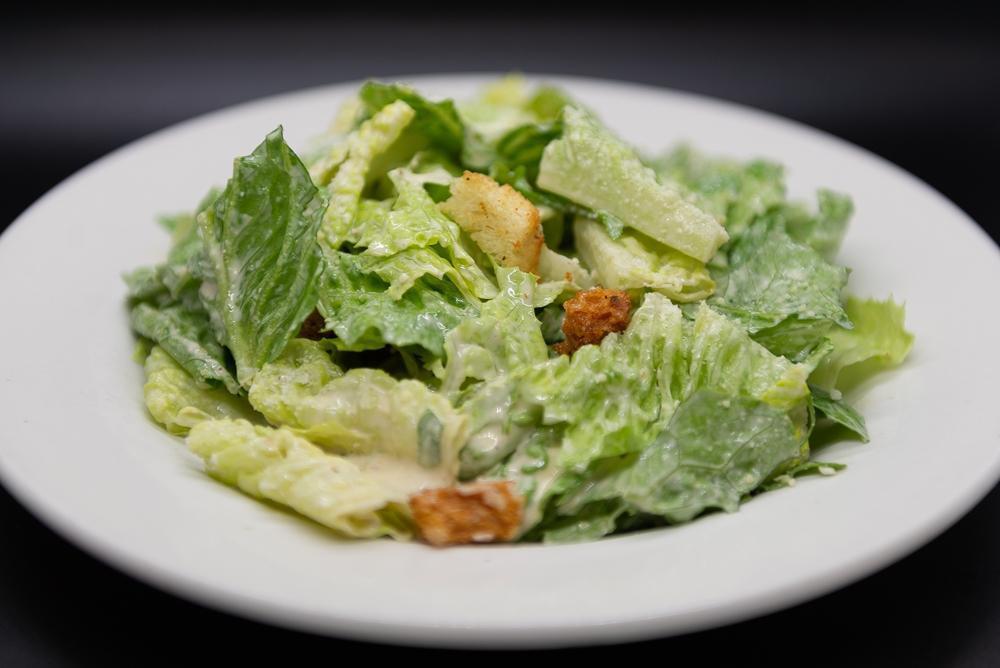 Side Caesar Salad · Romaine, Caesar Dressing, Garlic Croutons and Parmesan Cheese