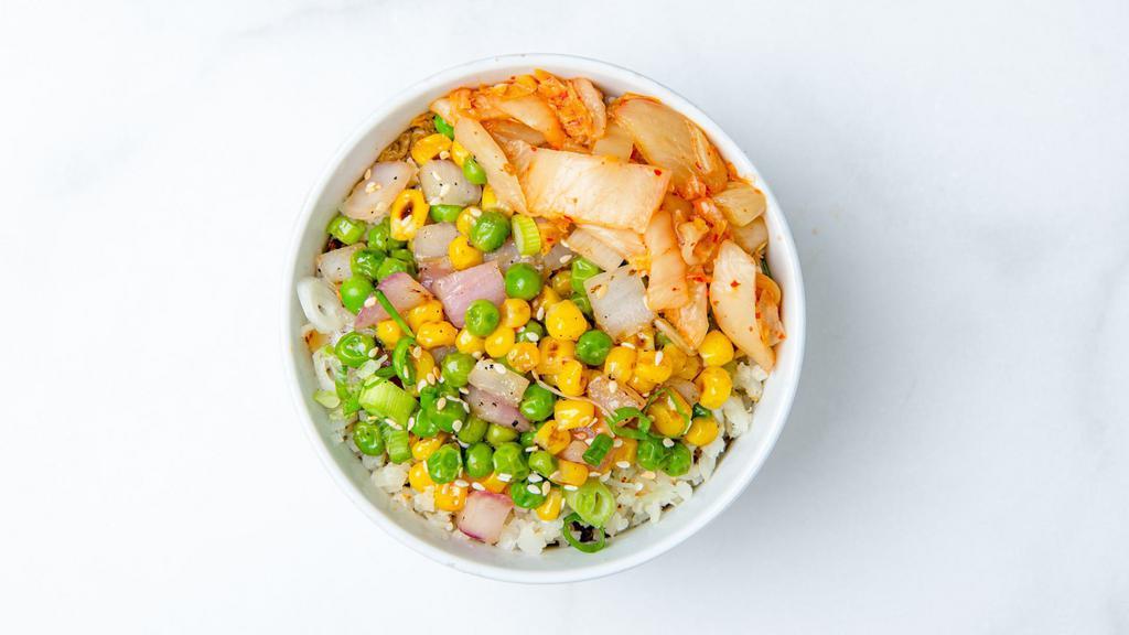 Kimchi Cauliflower Fried Rice · Roasted cauliflower rice, roasted corn, peas, green onions, and sesame seeds sautéed with our house-made ginger garlic sauce and served with kimchi and a protein of your choice. (Gluten-free & vegan)
