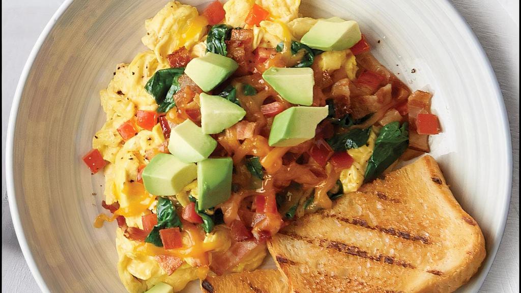 Bacon Avocado Egg Bowl · fluffy scrambled eggs topped with diced tomato, chopped baby spinach, Applewood smoked bacon, cheddar cheese and avocado served with sourdough toast