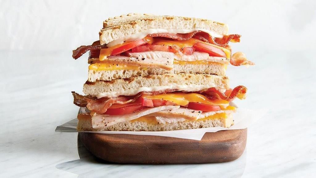 Club · oven-roasted turkey, bacon, cheddar, tomato, mayonnaise, grilled sourdough