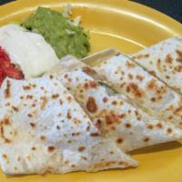 Quesadillas · A toasted flour tortilla filled with roasted mild poblano peppers, sautéed, onions, and jack...