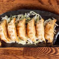 Gyoza (7 Pc) · Deep fried pork potstickers with a side of a soy vinegar and chili oil sauce.