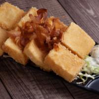 Agedashi Tofu · Drudged in sweet potato flour and fried. Topped with bonito flakes (fish flakes). Accompanie...