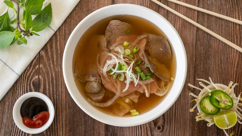 Pho Dac Biet · Combination of rare steak, well-done beef brisket, tendon, beef tripe, and meatballs. Served with a side of fresh basil and bean sprouts.
