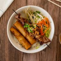 Bun Cha Gio Thit Nuong · Crispy egg roll and BBQ pork/chicken/beef or shrimp over rice noodle, minced cucumber, lettu...