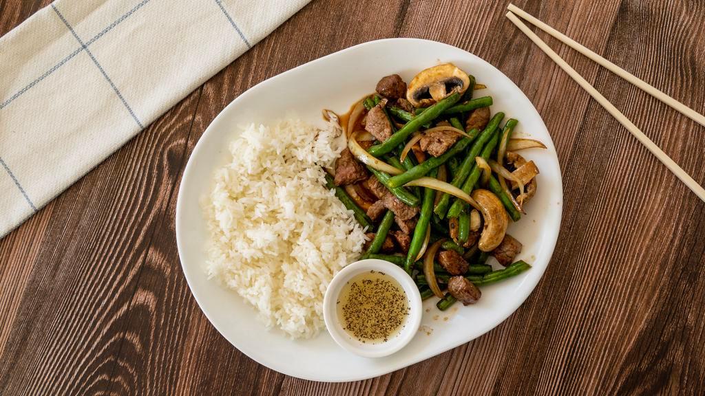 Com Bo Xao Luc Lac · Cubed beef steak stir-fried with green bean, mushroom, and onions served over rice.