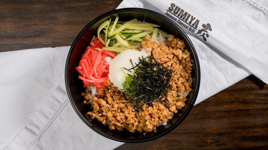 SOBORO DON BENTO · Flavored ground chicken w/ poached egg, cucumber, red ginger, green onion, dry seaweed and sesame seed over rice.  Comes with one choice of appetizer and a small salad.