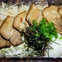 CHASHU DON BENTO · Pork chashu slices with poached egg, mayo, sesame seed, green onion and seaweed over cabbage...