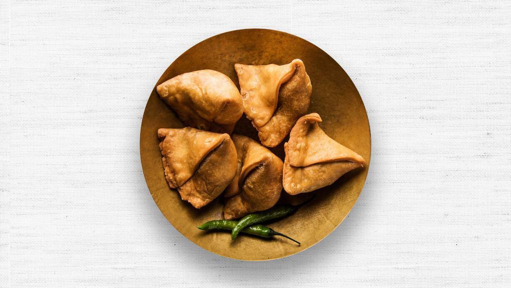Vegetable Samosas · Two vegetable samosas stuffed with green peas and potatoes. Served with tamarind and mint sauce.
