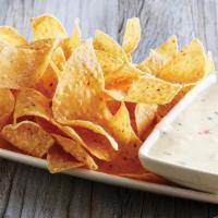 White Queso Dip & Chips · Melty white queso served with freshly made white corn tortilla chips.