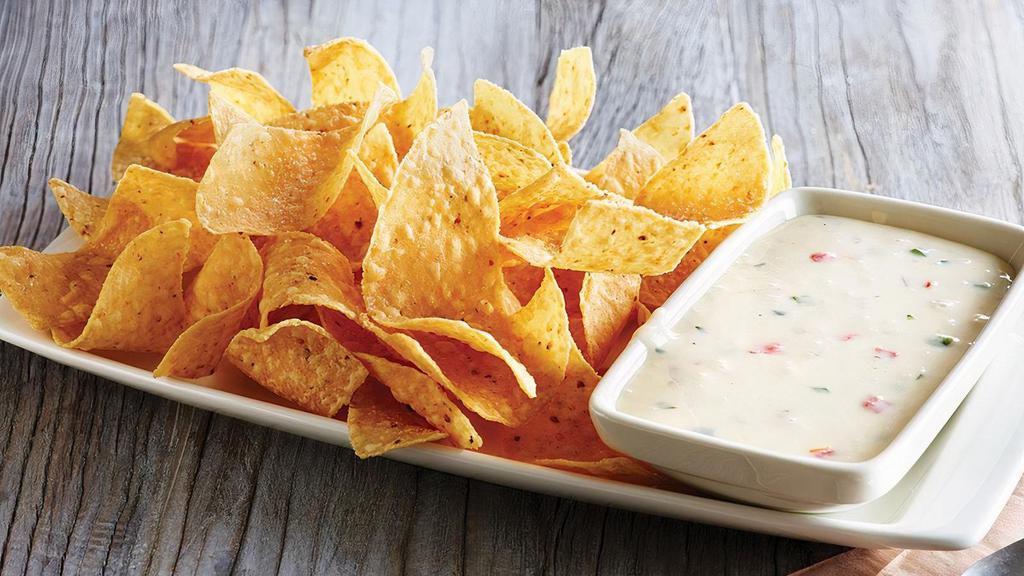 White Queso Dip & Chips · Melty white queso served with freshly made white corn tortilla chips.