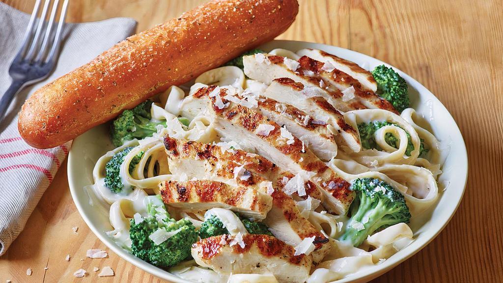 Classic Broccoli Chicken Alfredo · A neighborhood favorite. Juicy grilled chicken is served warm on a bed of fettuccine pasta tossed with broccoli and rich Alfredo sauce topped with Parmesan cheese. Served with a golden brown signature breadstick brushed with buttery garlic and parsley.