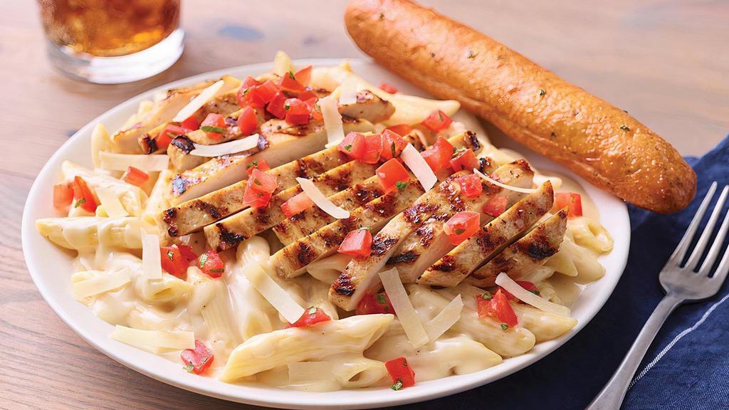 Three Cheese Chicken Penne · Asiago, Parmesan and white Cheddar are mixed with penne in a rich Parmesan cream sauce then topped with grilled chicken breast and bruschetta tomatoes. Served with a golden brown signature breadstick brushed with buttery garlic and parsley.