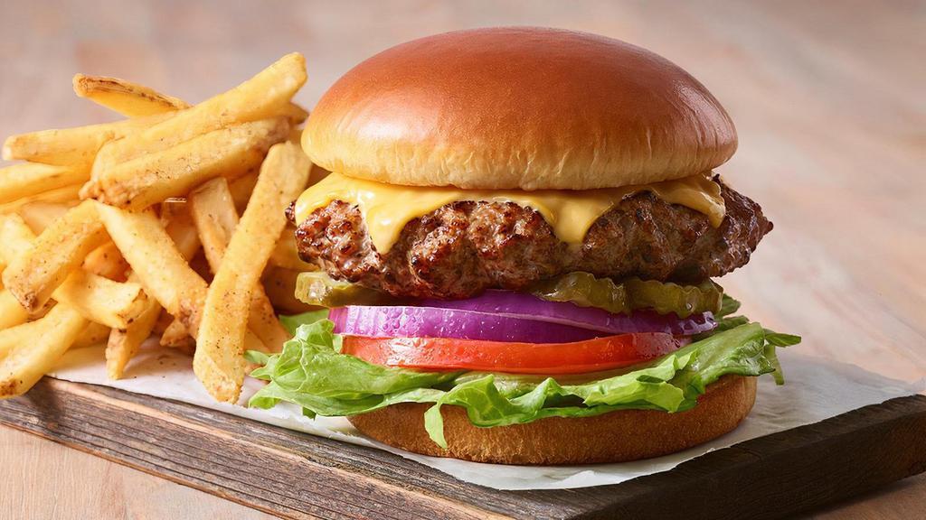 Classic Cheeseburger · Go old school with our handcrafted all-beef patty topped with two slices of American cheese. Served with lettuce, tomato, onion and pickles on a Brioche bun. Served with classic fries.