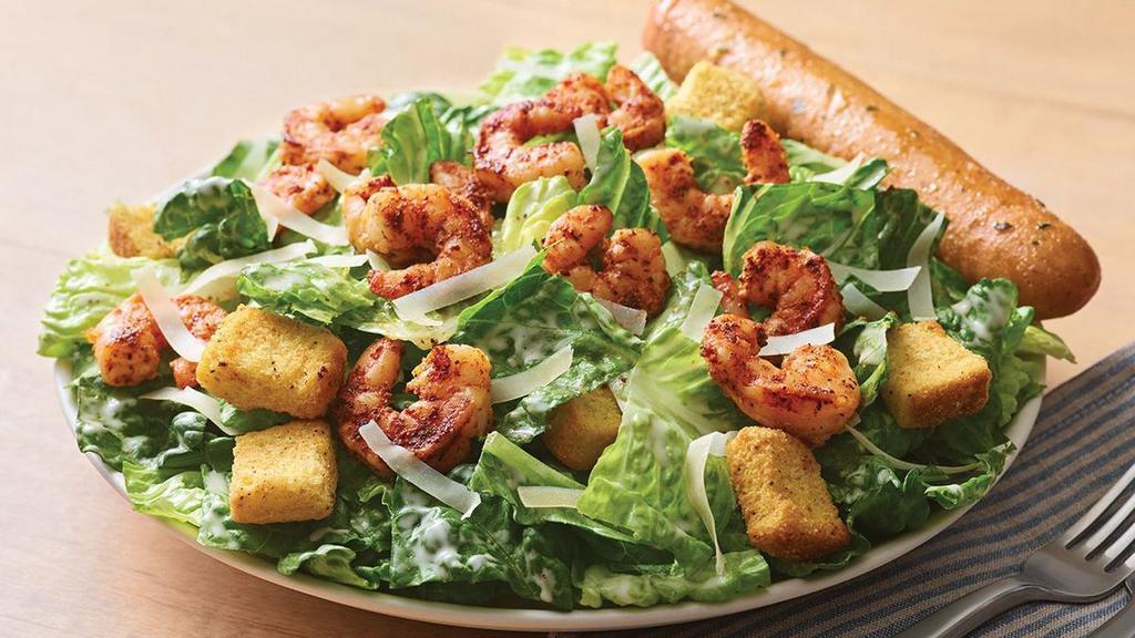 Blackened Shrimp Caesar Salad · Crisp romaine topped with blackened shrimp, croutons, shaved Parmesan and garlic Caesar dressing on the side. Served with a golden brown signature breadstick brushed with a buttery blend of garlic and parsley.