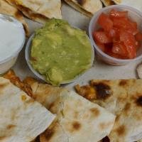 Beef Quesadillas · Flour tortillas filled with seasoned ground beef grilled and served with fresh guacamole, so...