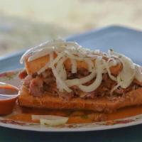 Torta Ahogada · Jalisco Style Sandwich, Choice of Carnitas on Buche, Beans, Mild Salsa, Onion and on top.(Sp...